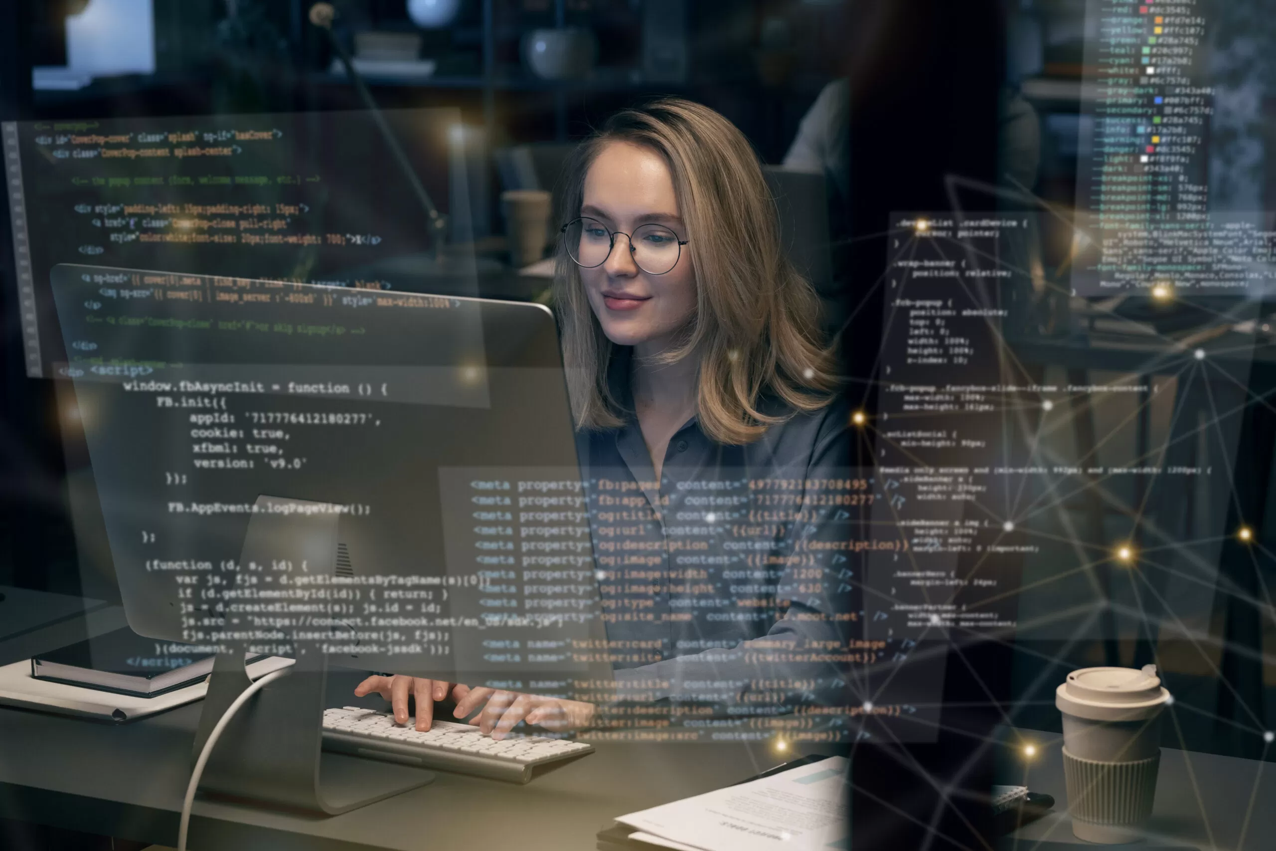 a girl sitting in front a computer and doing coding